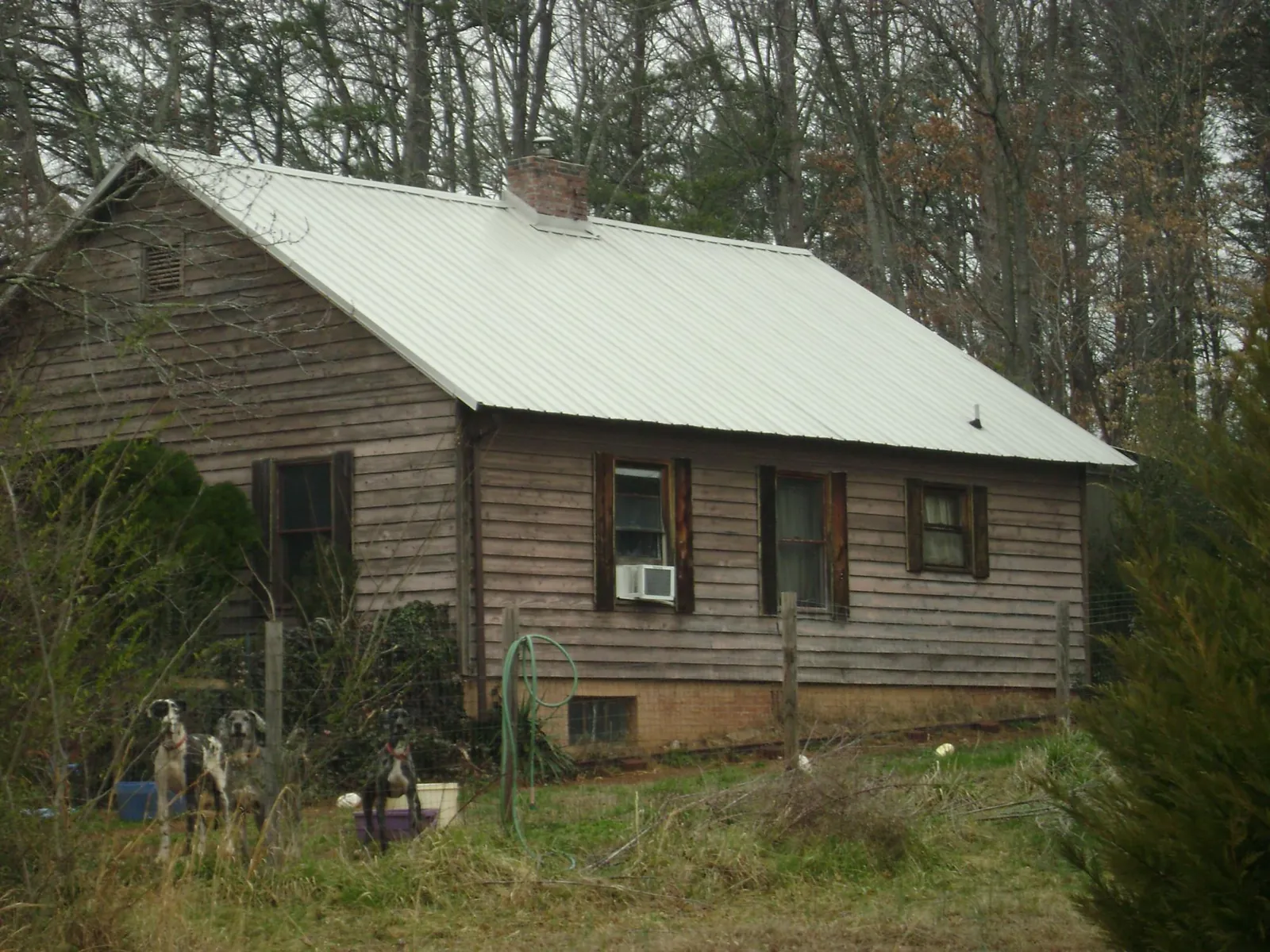 White metal roof on an old wood sided farmhouse, from a Asphalt Shingle Roof Repair job in Hendersonville